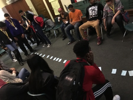 The Karabots Junior Fellows examine cards on which they have written what they want to learn during their upcoming trip to Eastern State Penitentiary