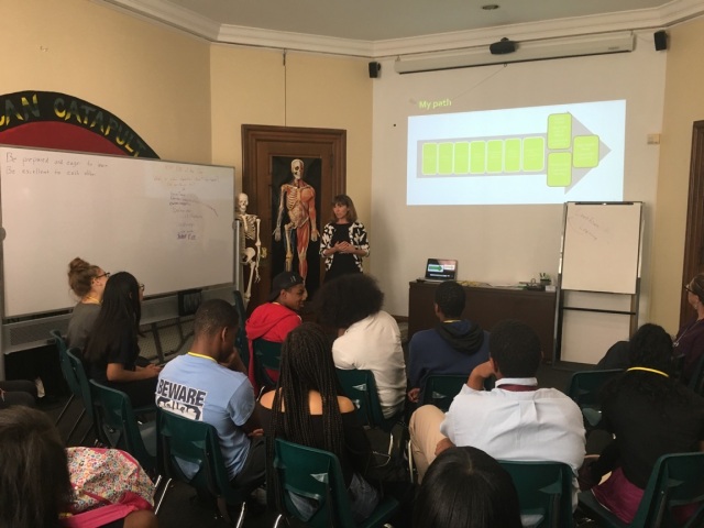 Students in the Karabots Junior Fellows Program observe a slide presented by Dr. Laura Offutt as part of a lesson on teen health